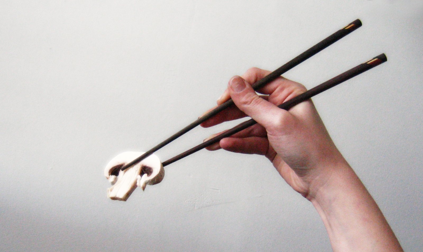 two sticks being pulled up by someone holding an object