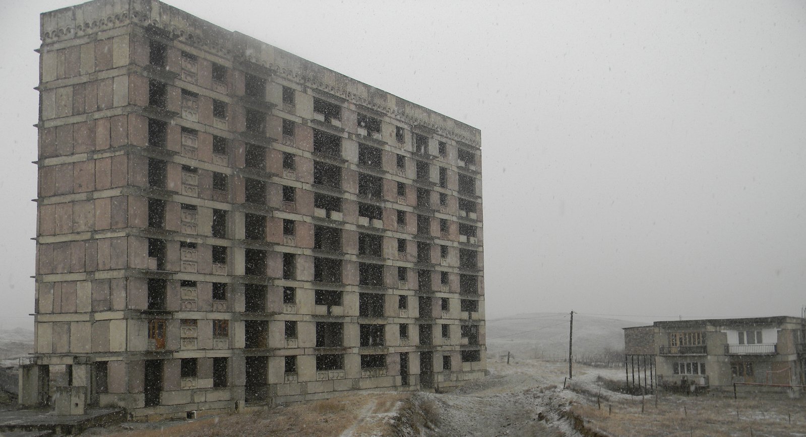 a large brick building that is next to the snow