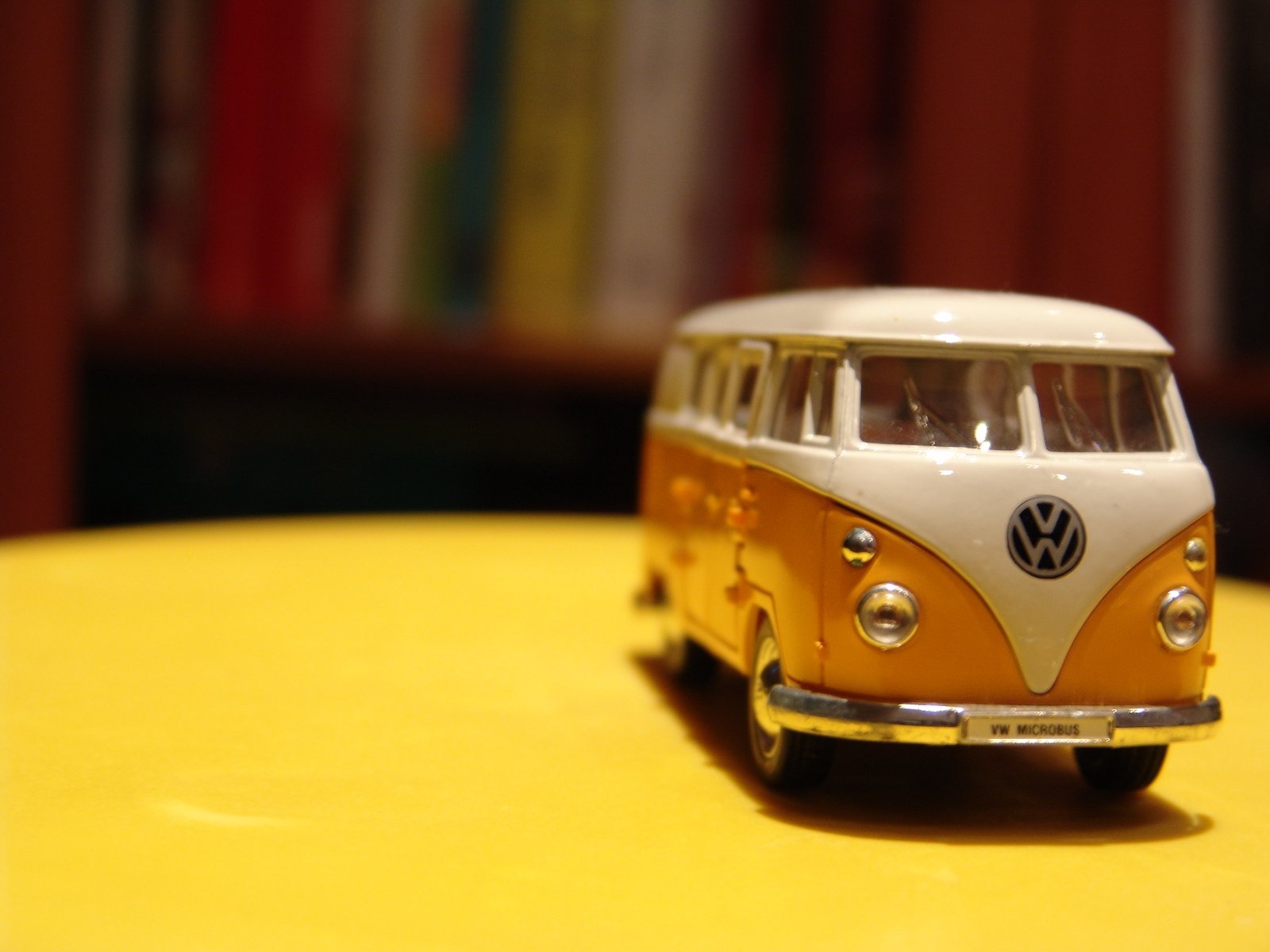 a yellow and white bus on a yellow table