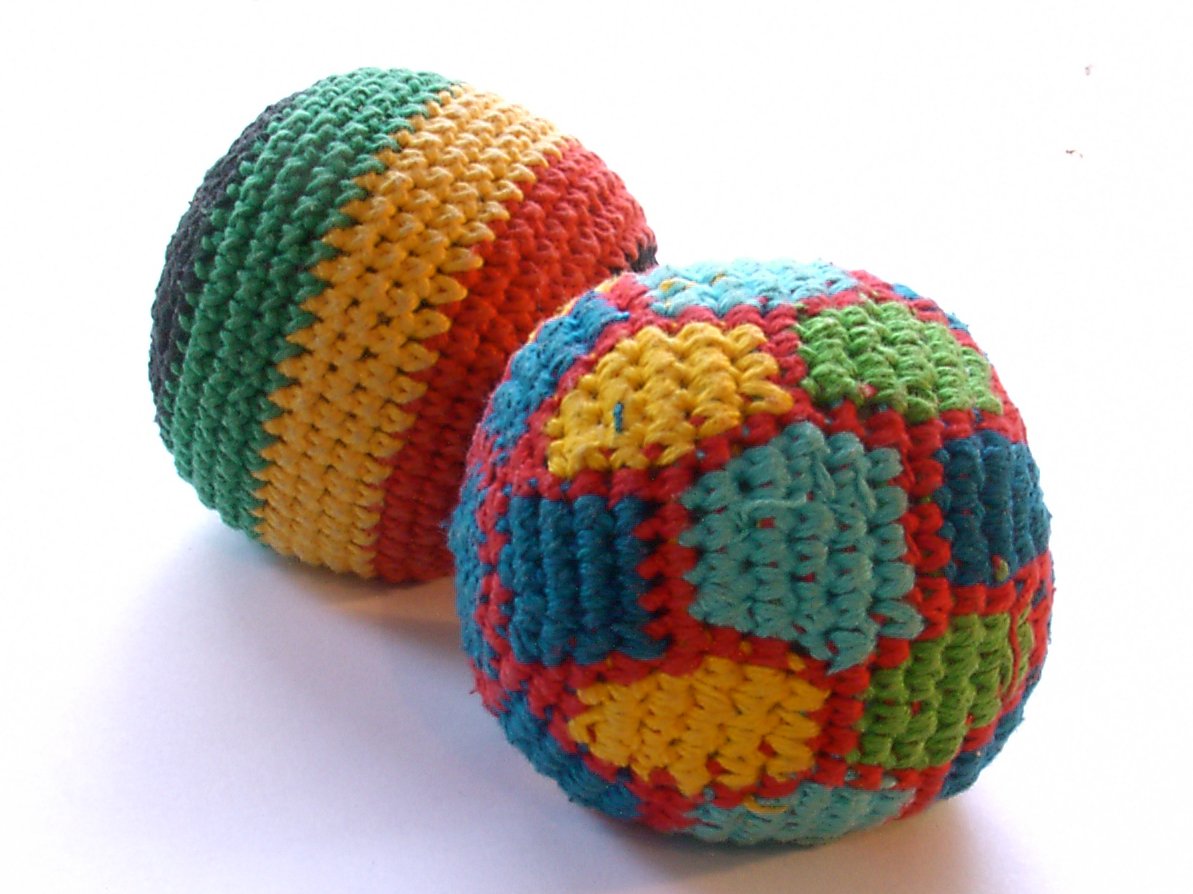 colorful crocheted balls sitting on top of each other