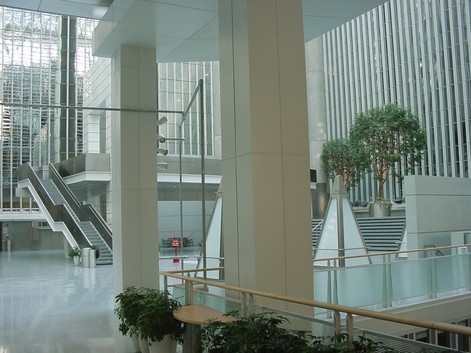 an empty lobby with plants and stairs
