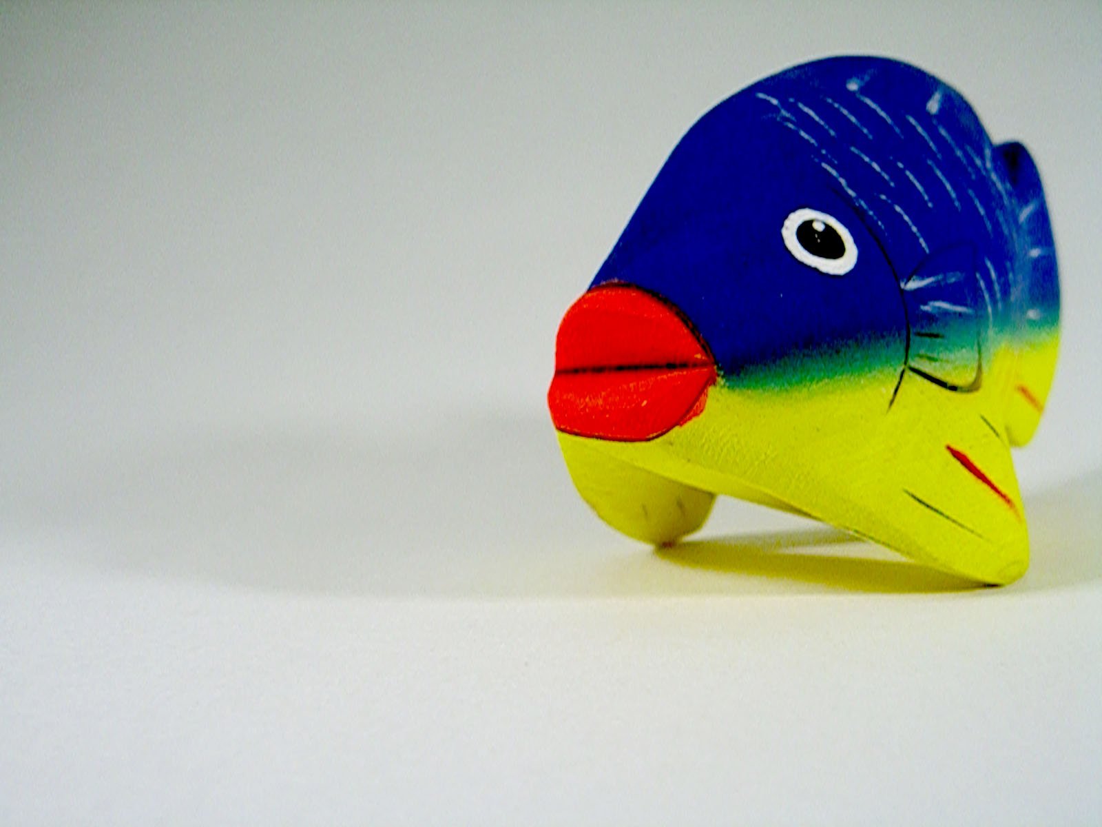 this is a blue, yellow, and orange fish toy