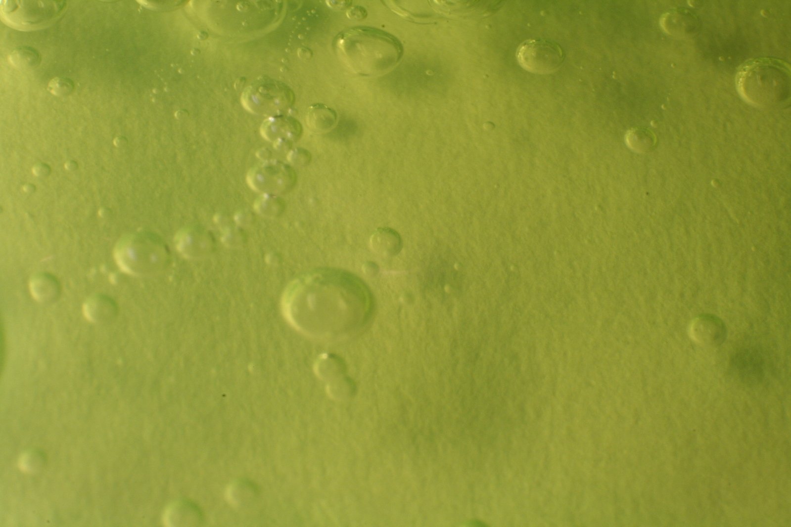 water droplets on a green surface, with some green in background