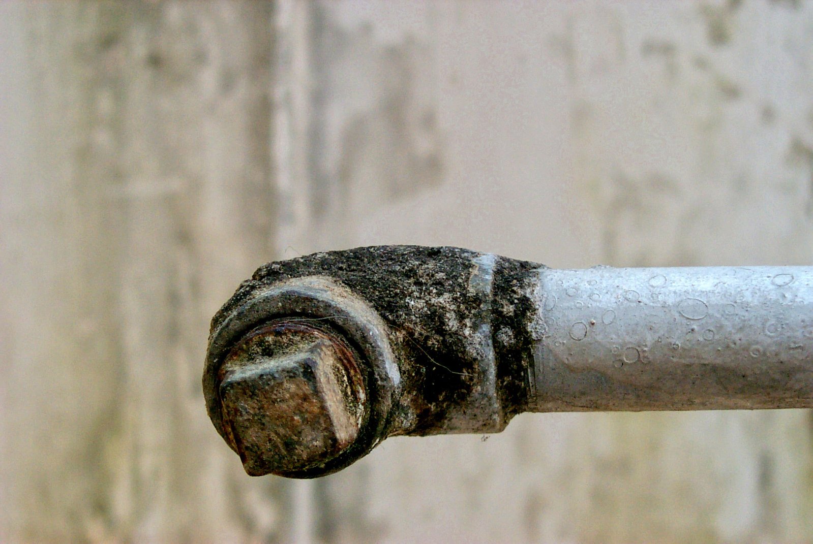 a pipe with rust and water on it