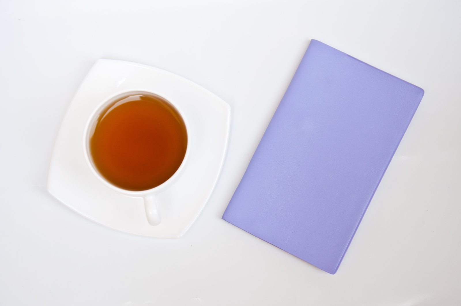 cup of tea and a blank card on a white table