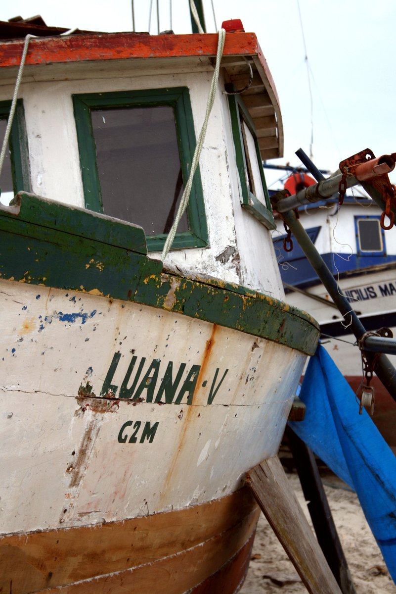 two boats docked next to each other with a sky background