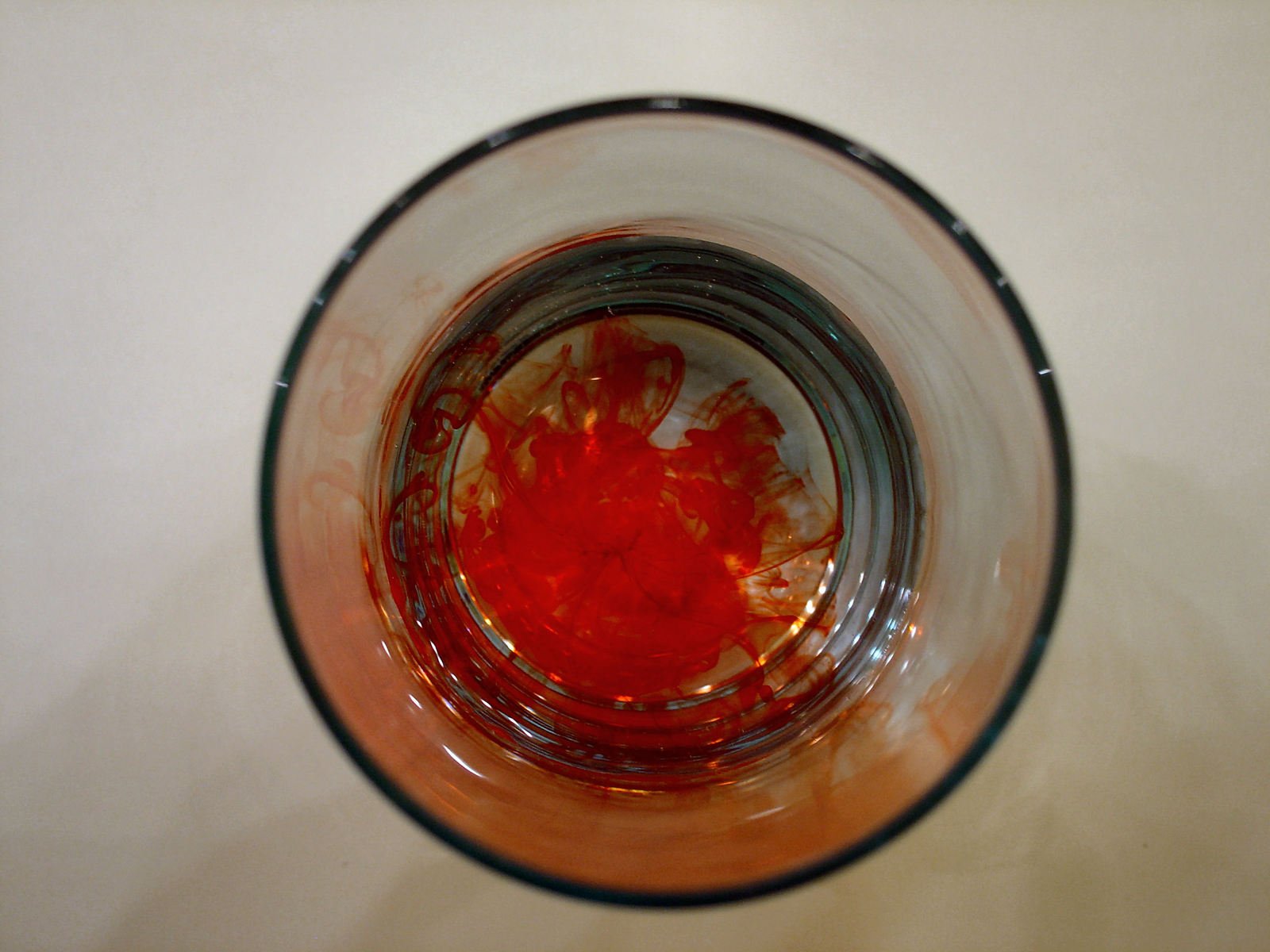 an extreme closeup of some wine in a glass