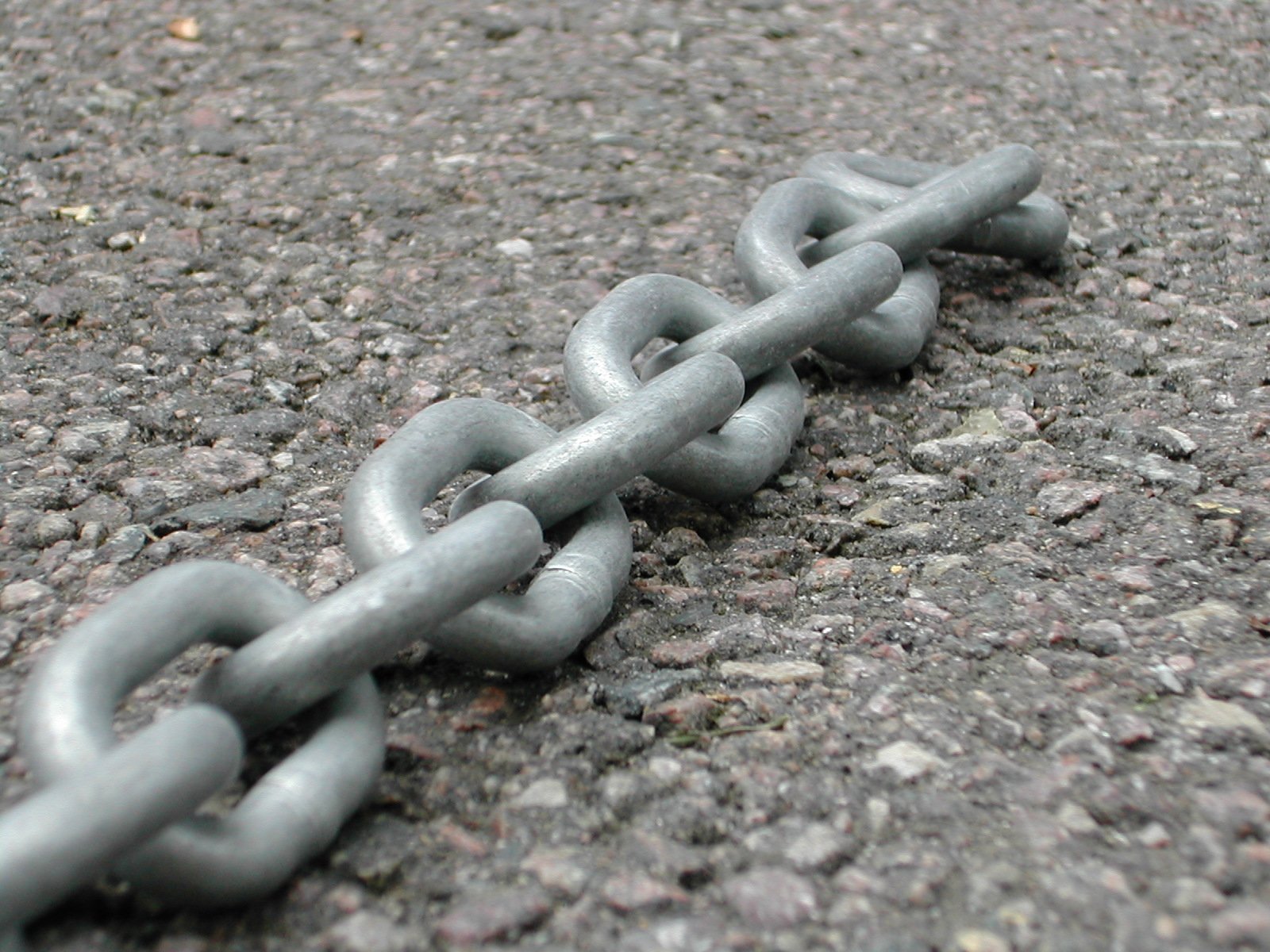 chain on ground, with one broken, has one missing