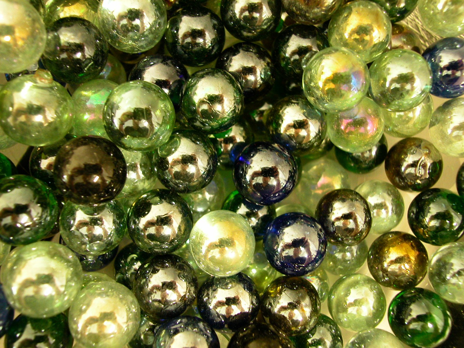 many green, blue and silver beads are grouped together