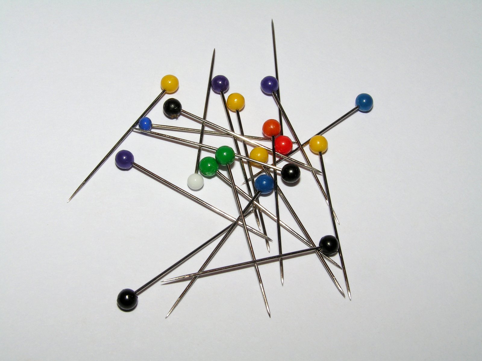 a closeup of an assortment of pins on a stick