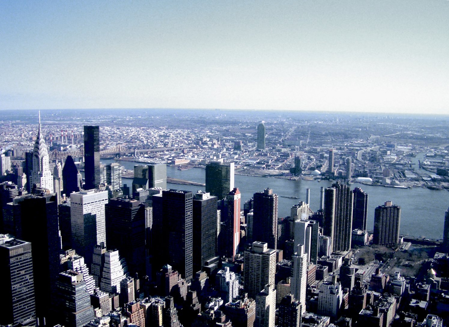 an aerial view of new york city with a lot of tall buildings