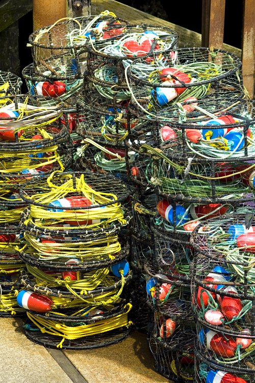 many large groups of assorted wire baskets are stacked together