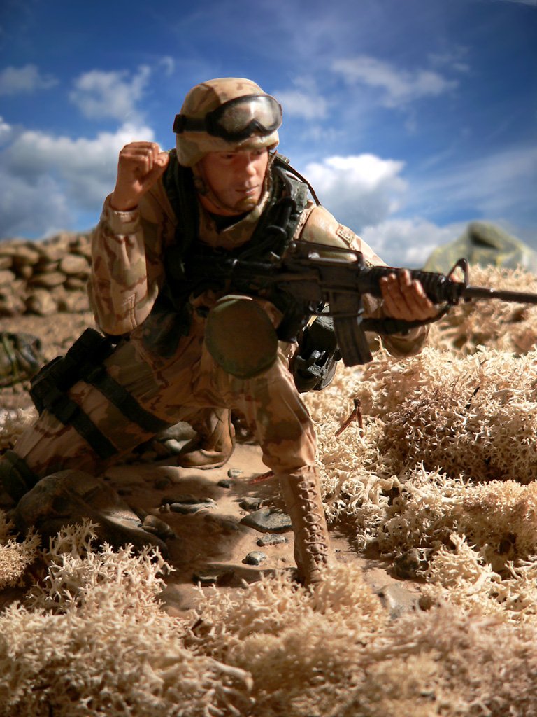 a model soldier from the vietnam war is posed on top of a hill