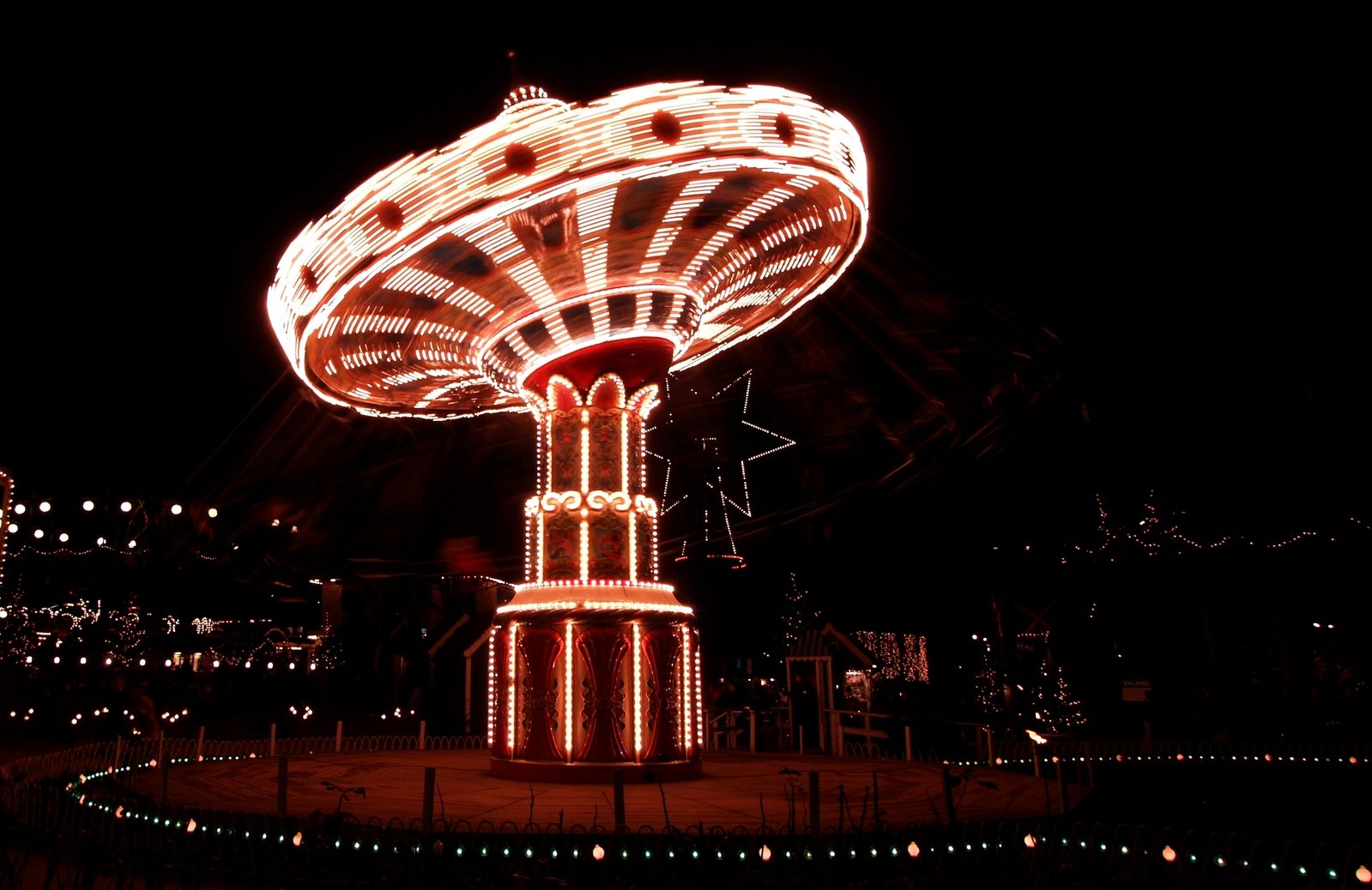 a merry go round with lights on at night