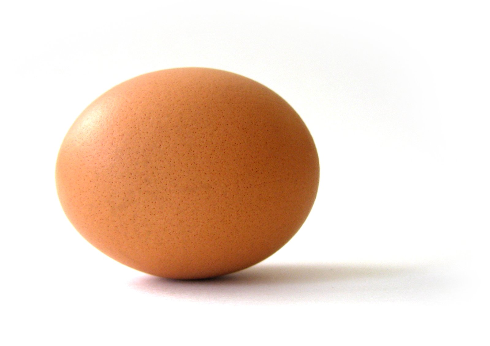 an egg laying down on top of a white table