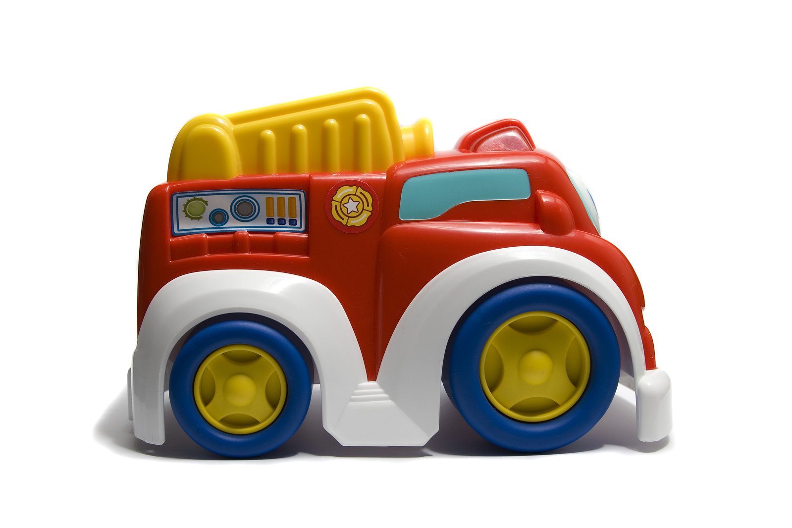 toy fire truck with wheels sitting on top of a white surface