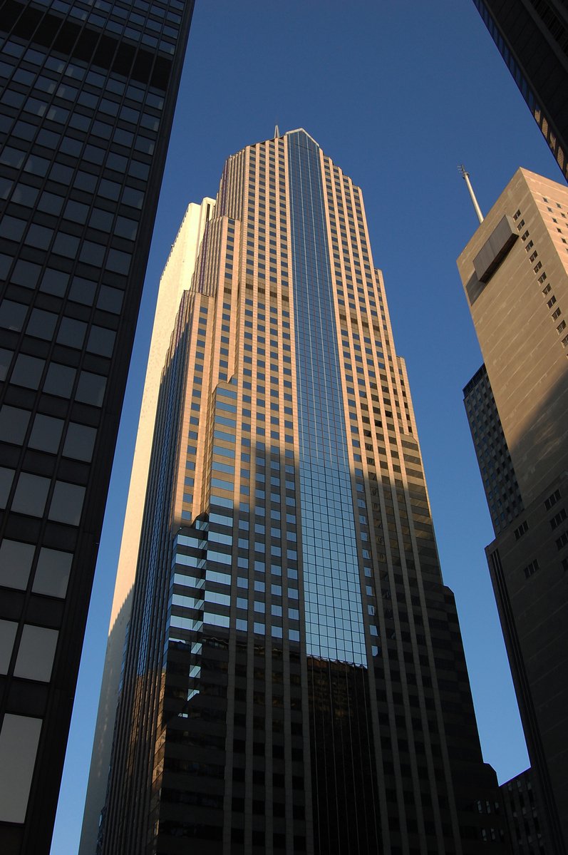 a very tall office building towering over a city