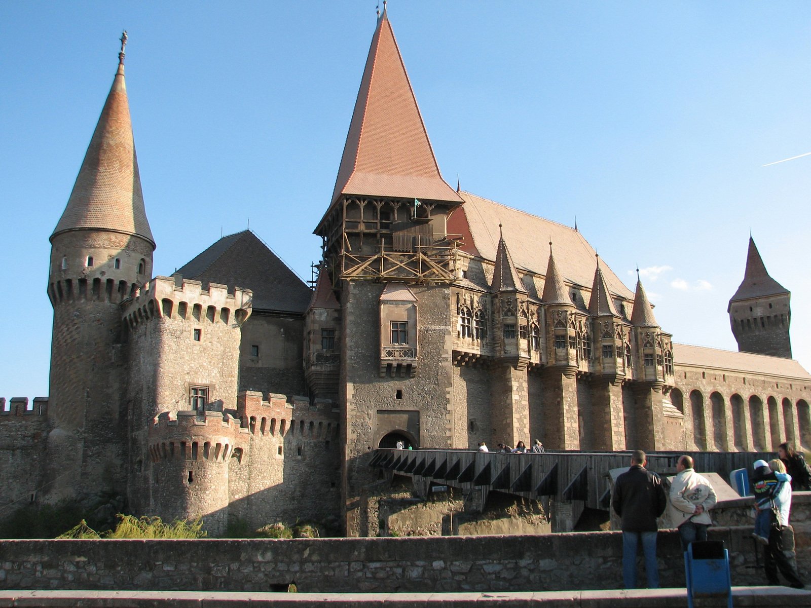 people walking around a large castle like structure