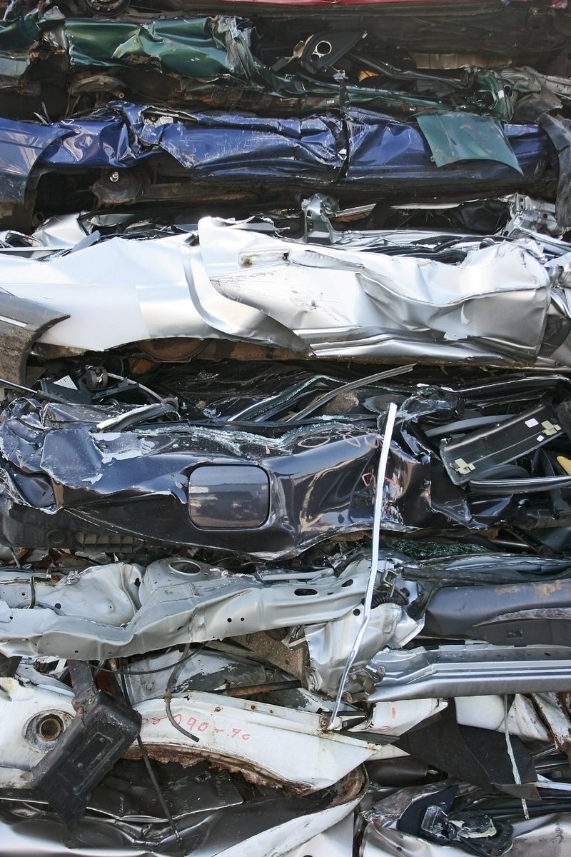 a pile of old cars with no tops and parts