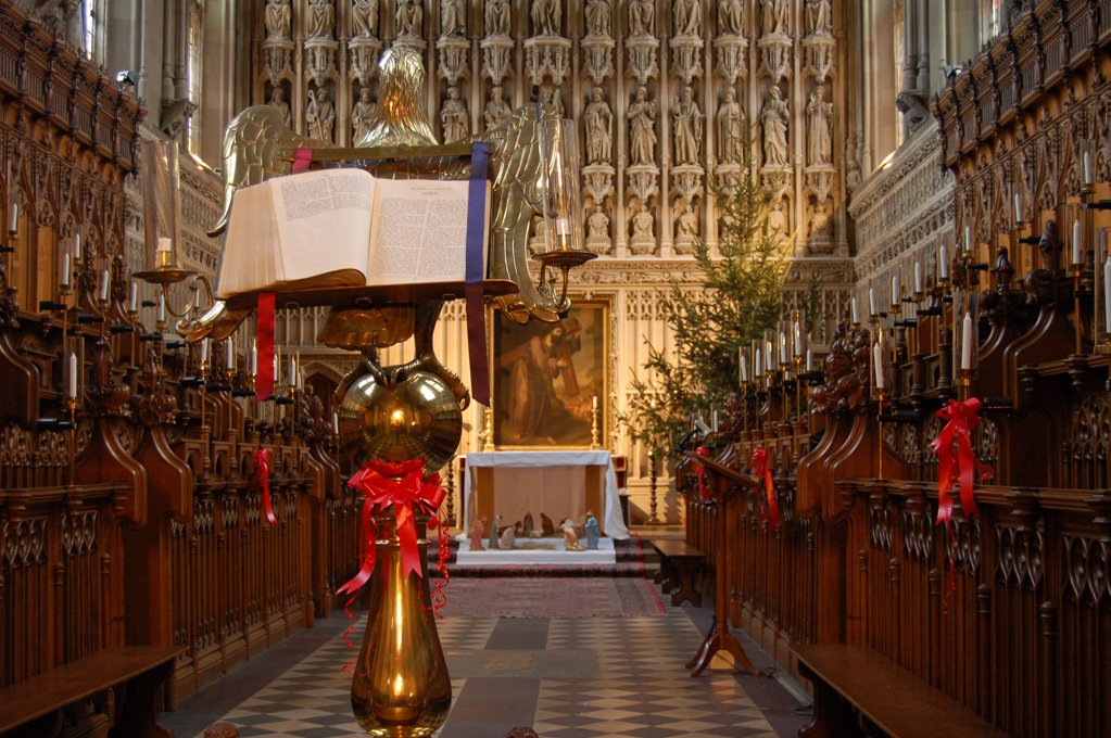 the alter of an older church with candles and religious books