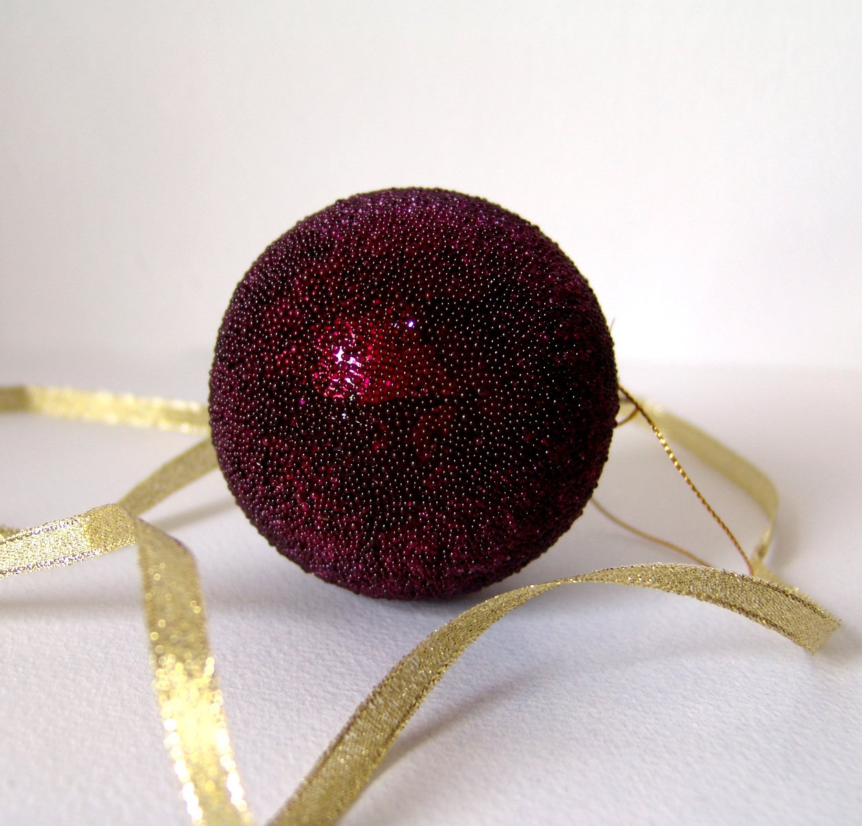 a small red ball that is covered in metallic glitter