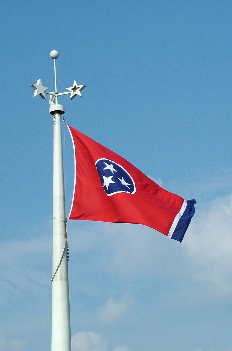 a flag pole with a star and a flag on top