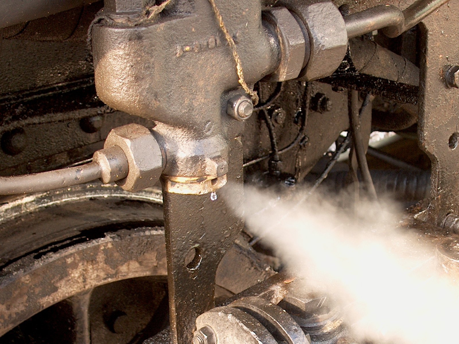 a picture of a person spraying a machine with some steam