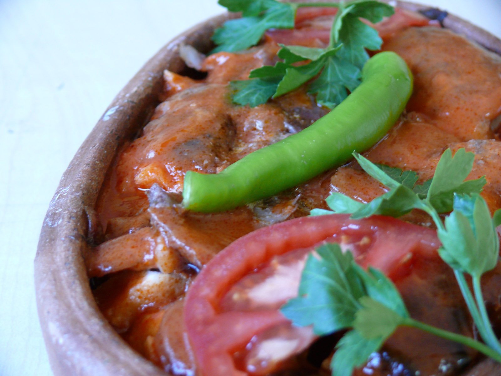 a pan with vegetables and sauces that include a red pepper, beans and peppers