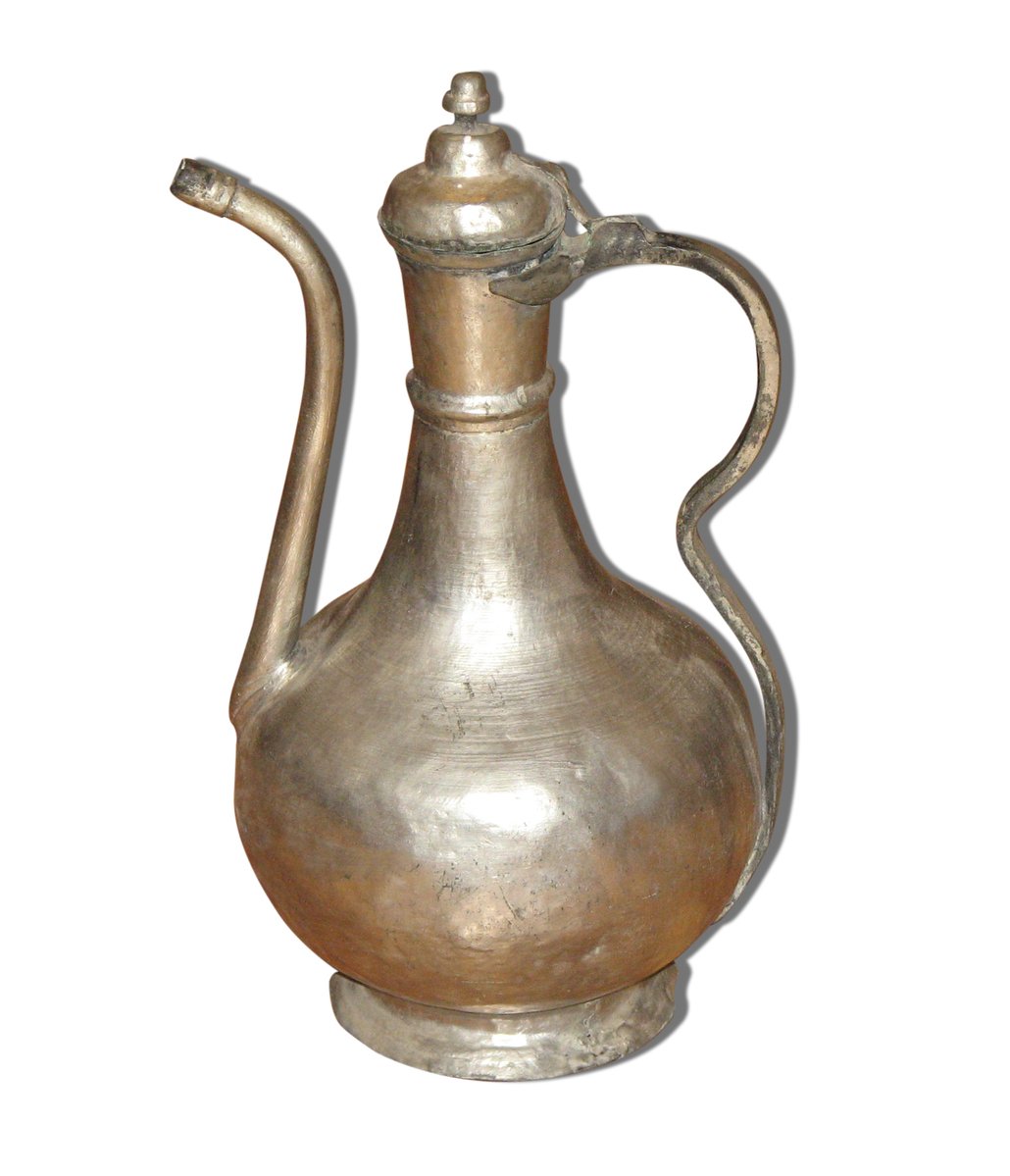 an antique ss pitcher with a wooden handle