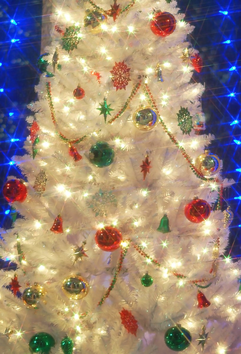a white christmas tree with colored ornaments on it