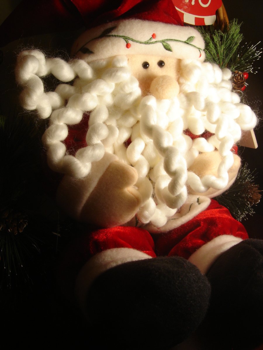 a christmas decoration made of cotton swaddled into santa claus's face