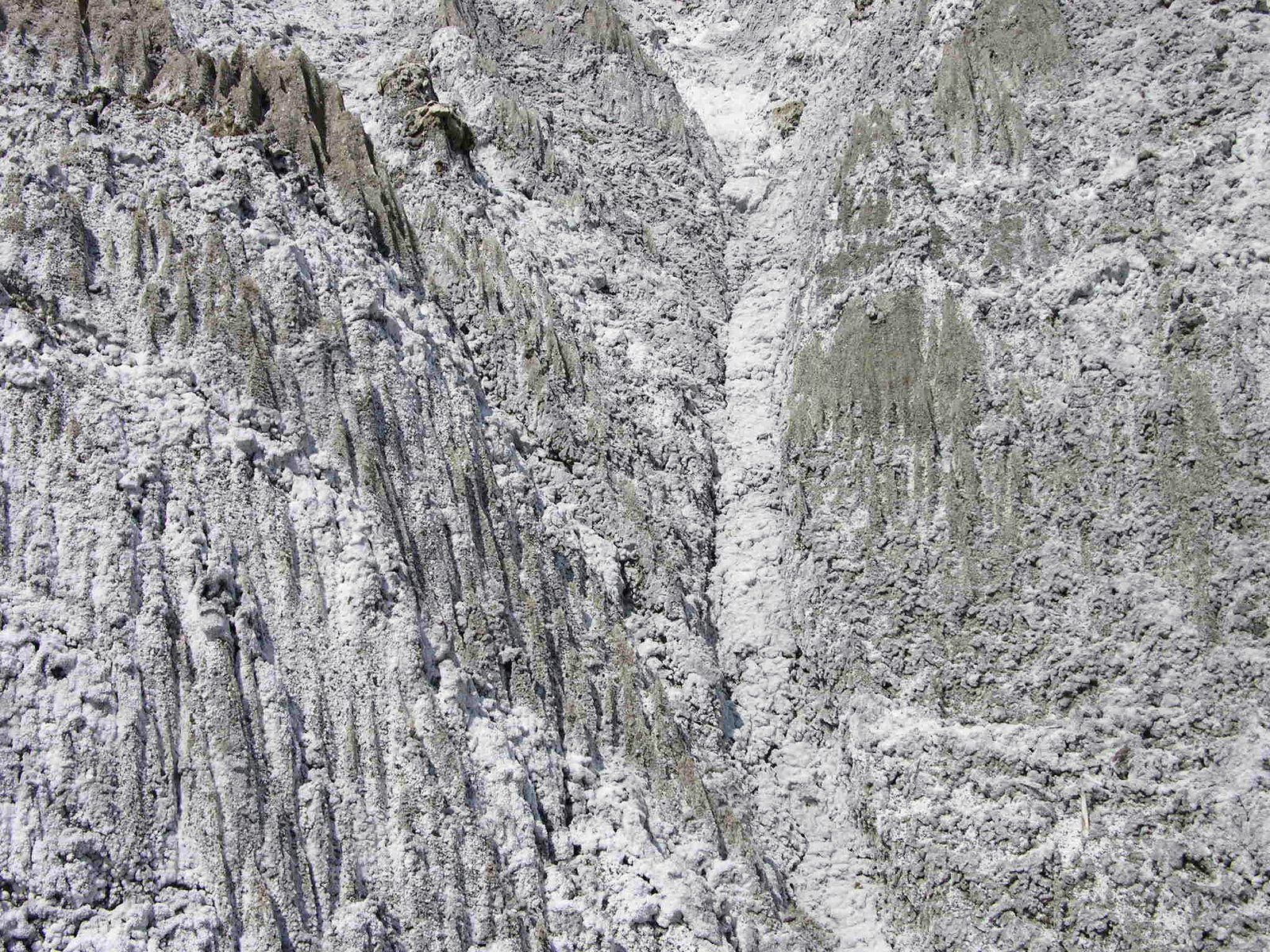 a landscape picture of snow and rocks in the mountains