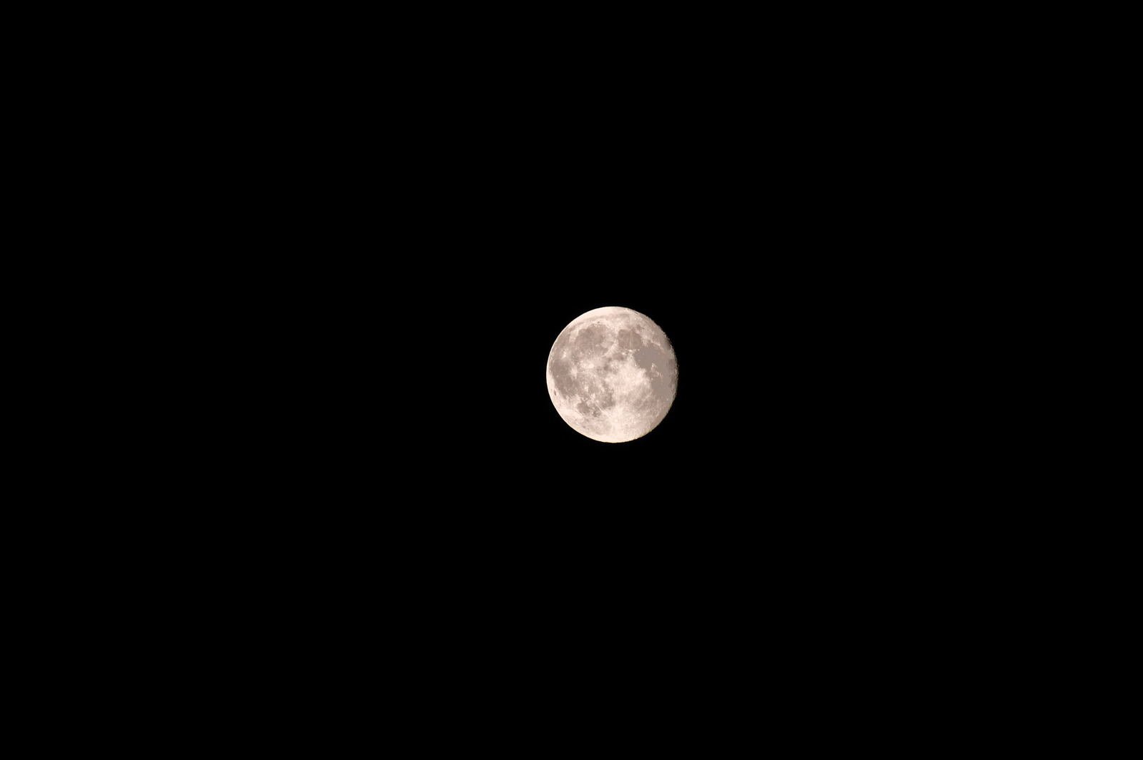 the moon with black sky in the background