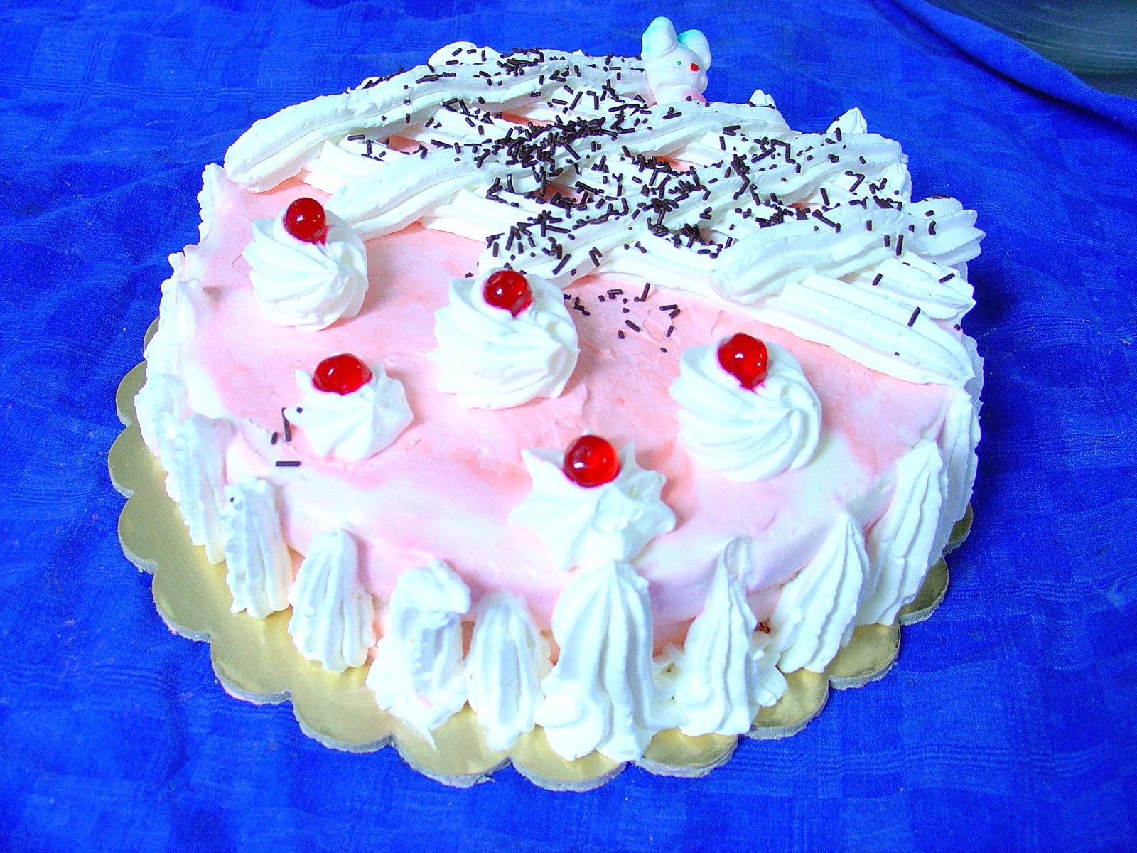 a cake on a plate with frosting and fruits