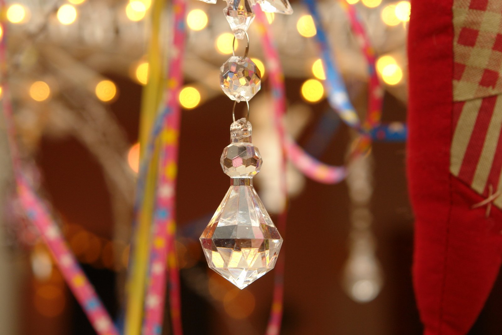some crystal hanging ornaments and lights in the background