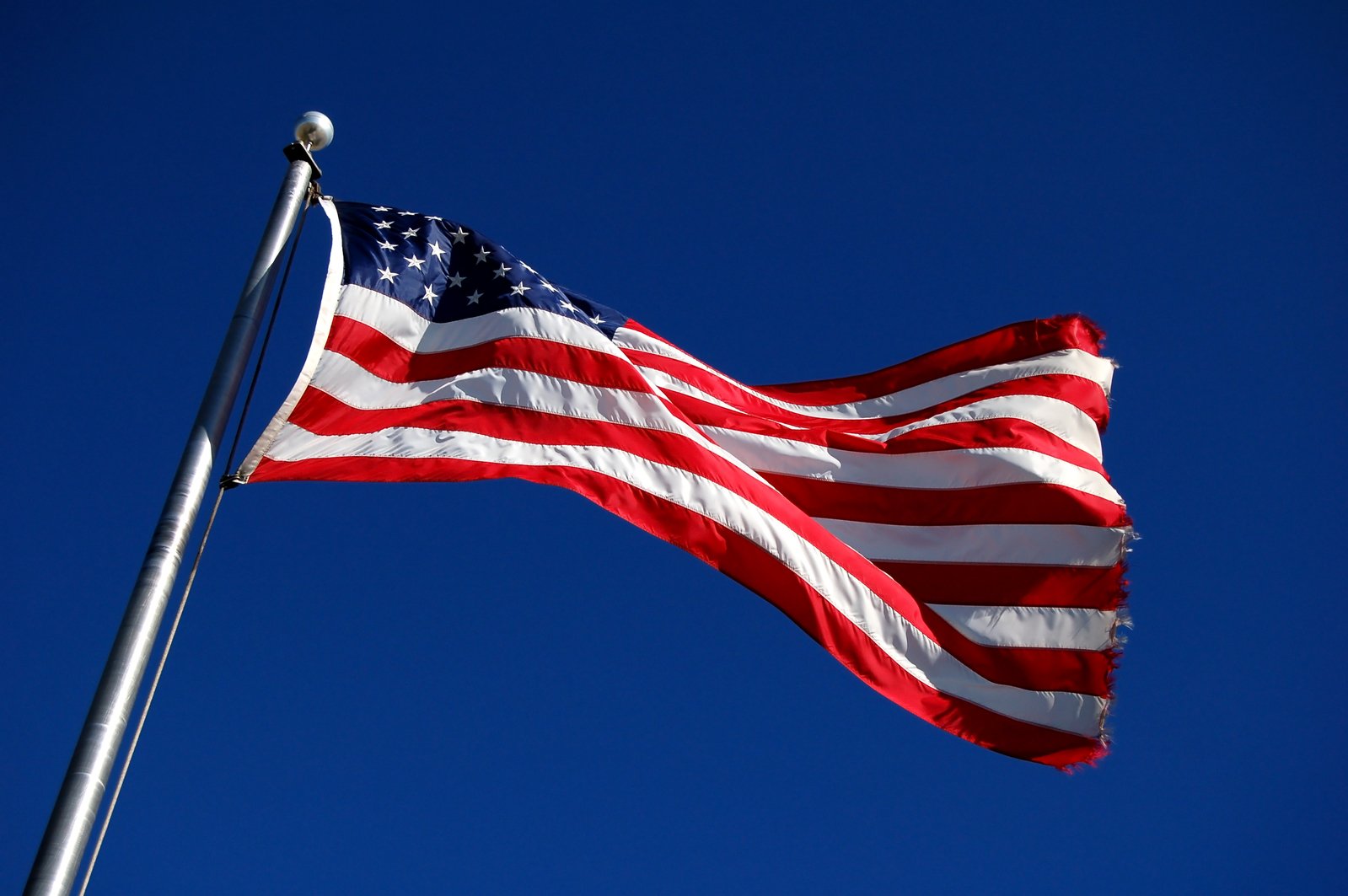 an american flag flies high in the air