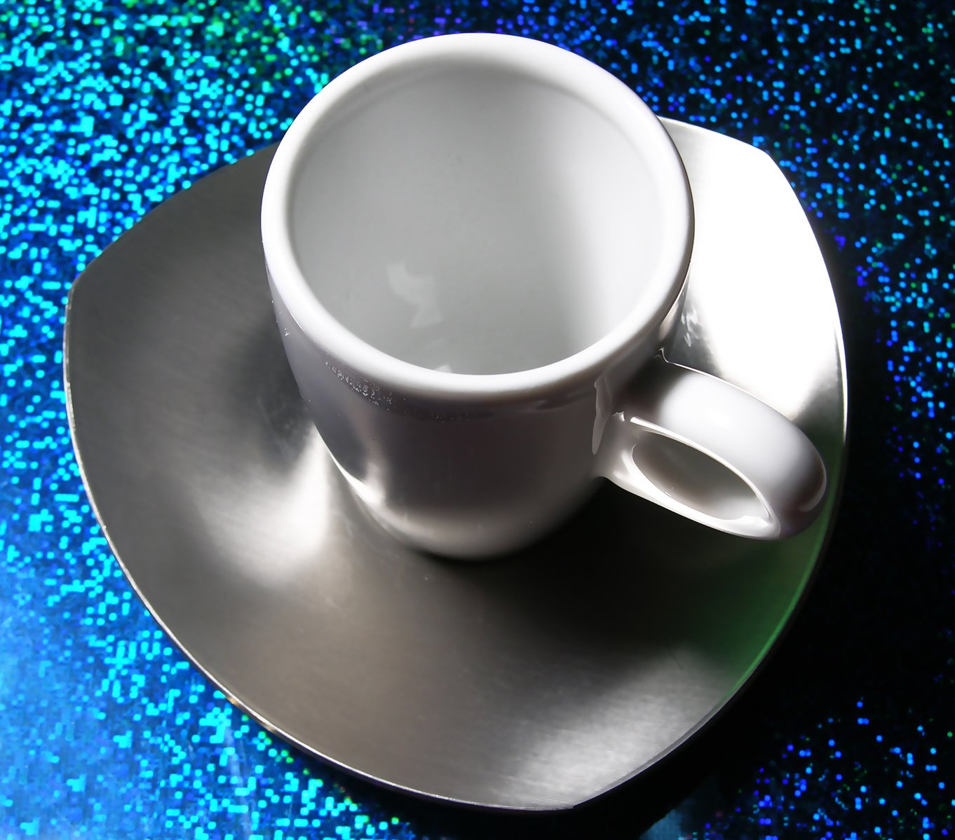 a white coffee cup on a saucer on a table