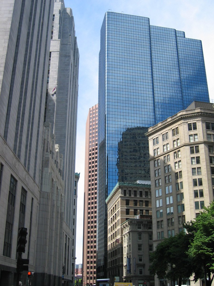 several tall buildings rise above a city street