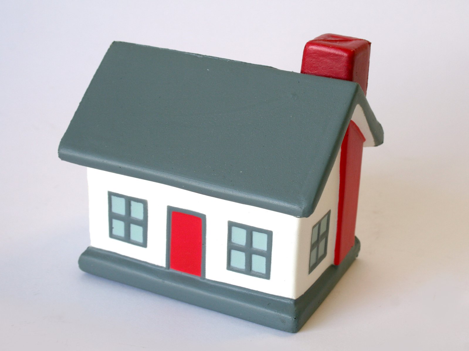 a toy model of a house with a red roof