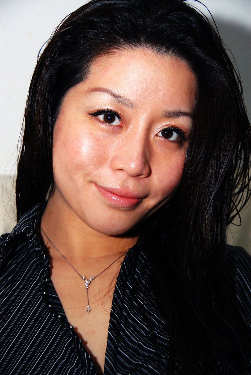 an asian woman in a black shirt has long hair