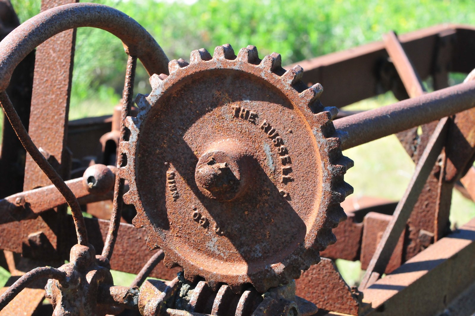 a rusty gear on an old, rusted piece of machinery