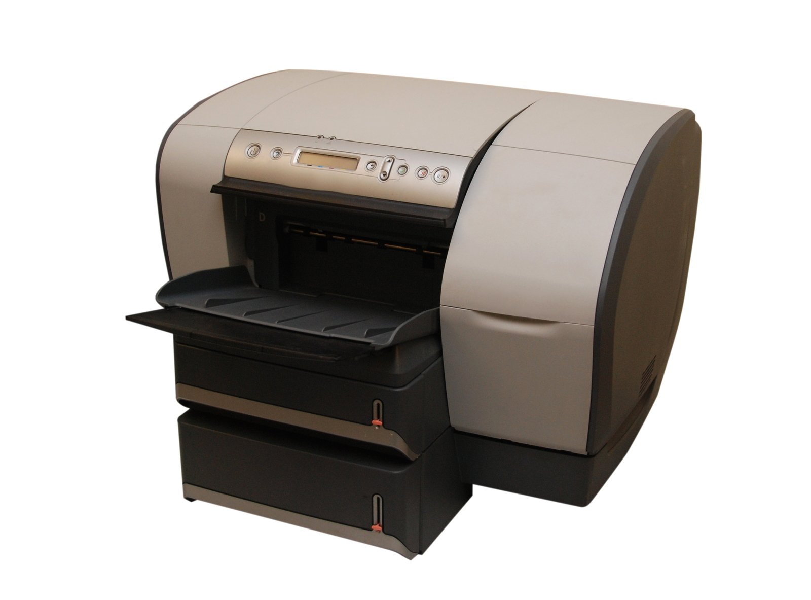an automatic inkjetting machine sitting next to a white wall