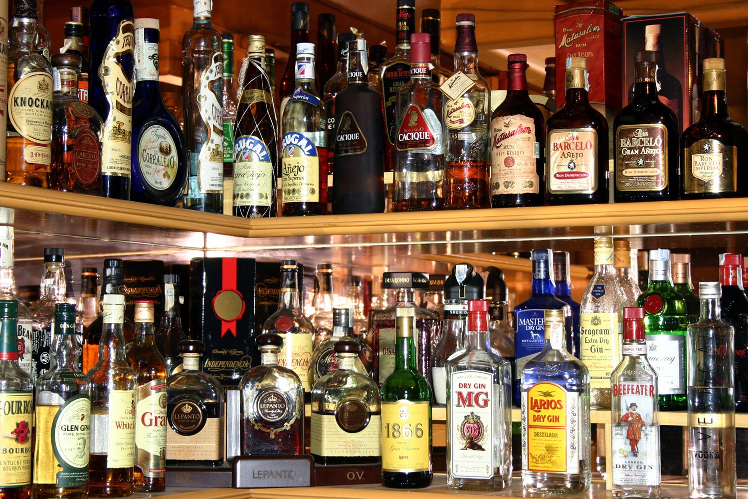 bottles of alcohol on shelves of bar tops