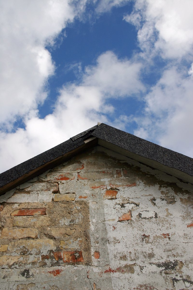 a brick building with a blue sky above it