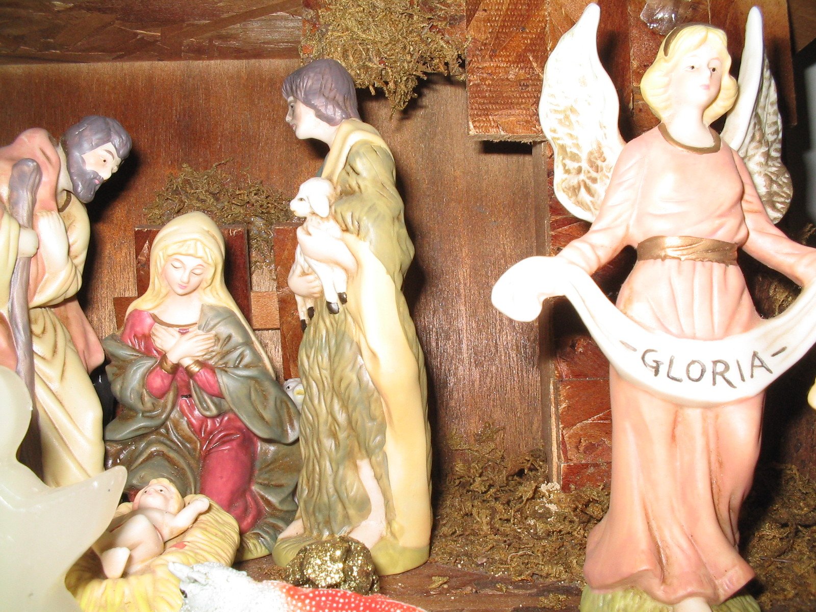 nativity scene of three people, three angels and a baby jesus