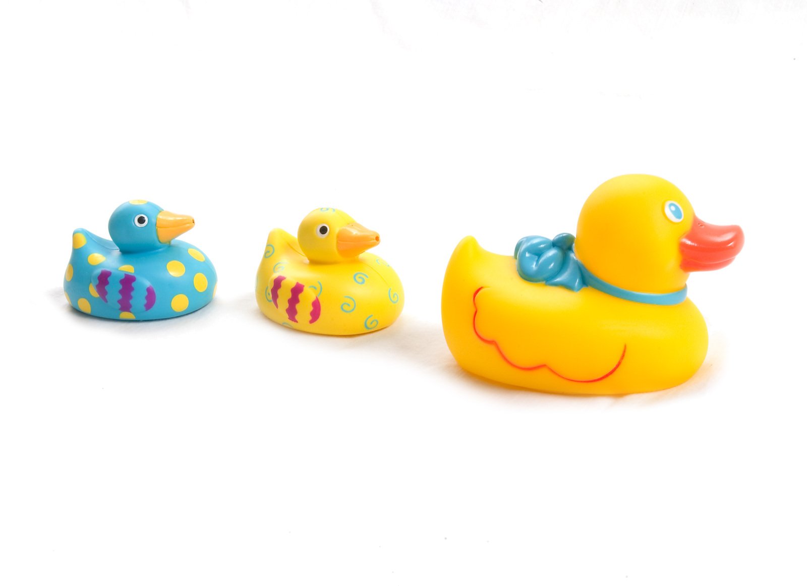 three rubber ducks and two rubber rubber toy ducks