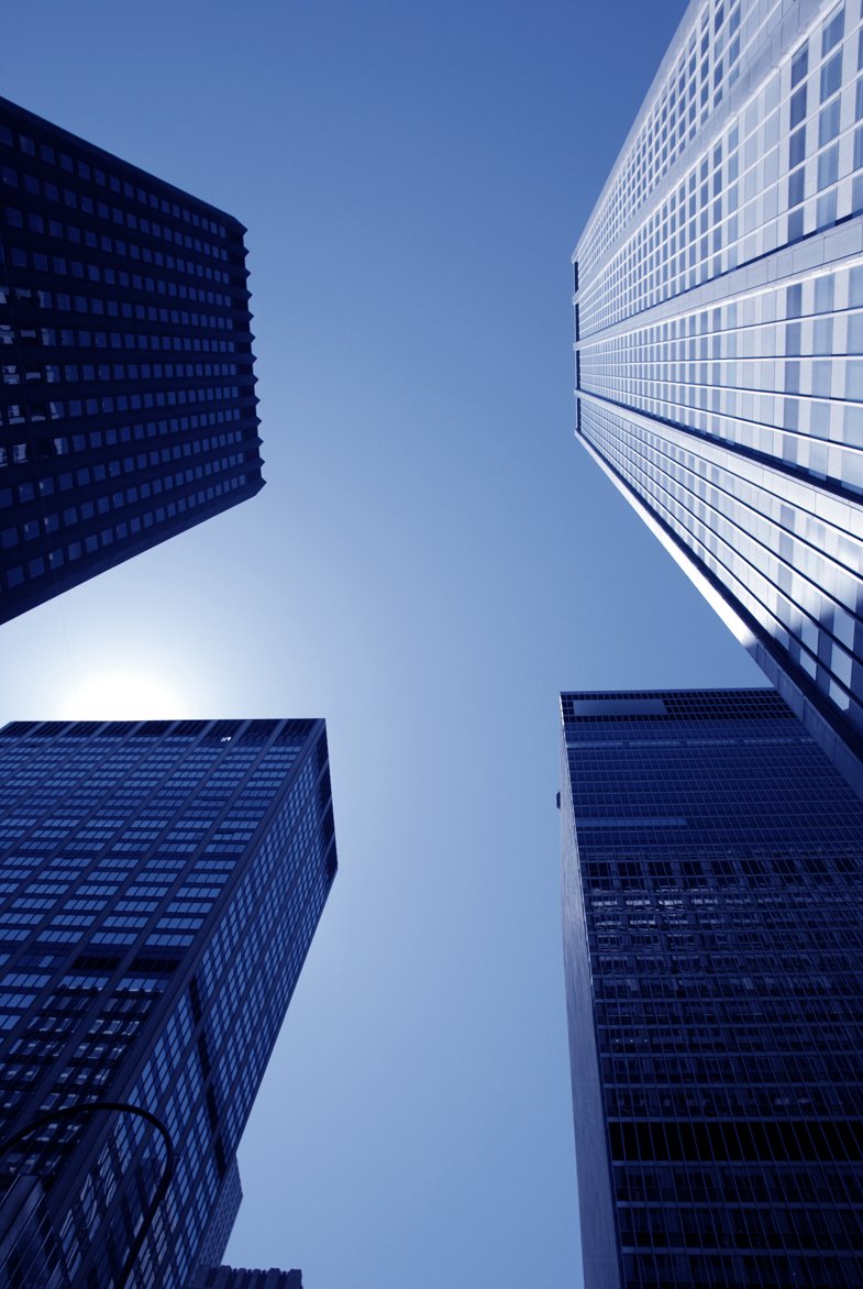 looking up at a group of tall buildings