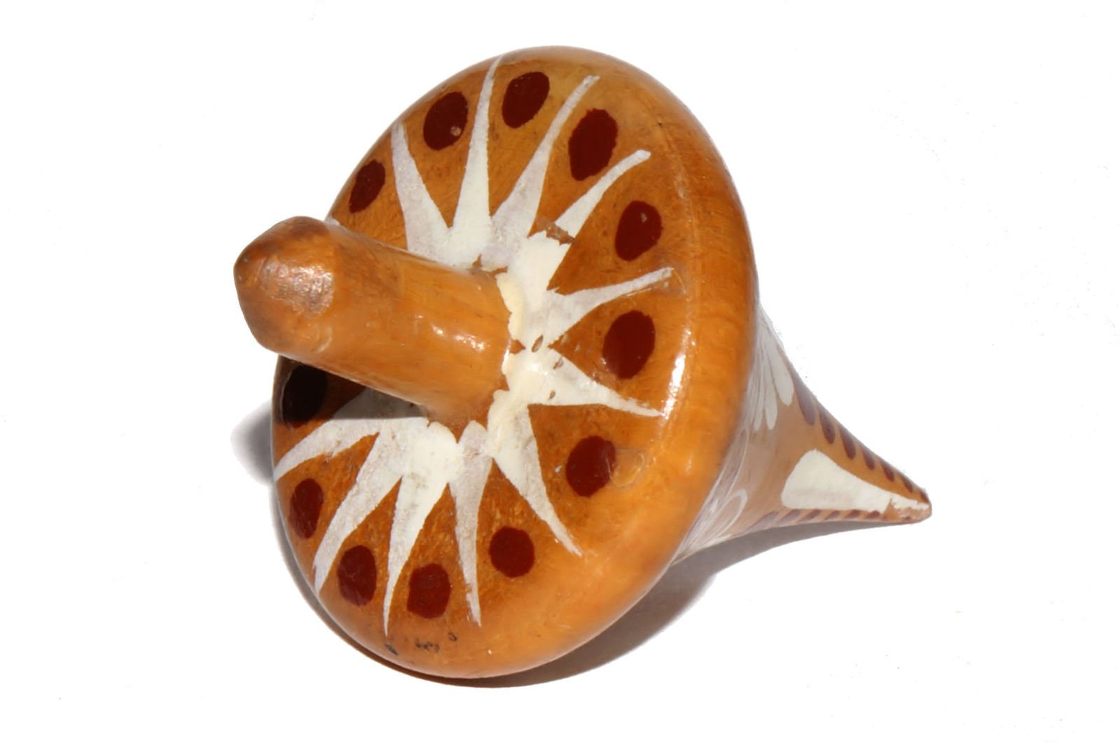 a small orange and white object sits on a table