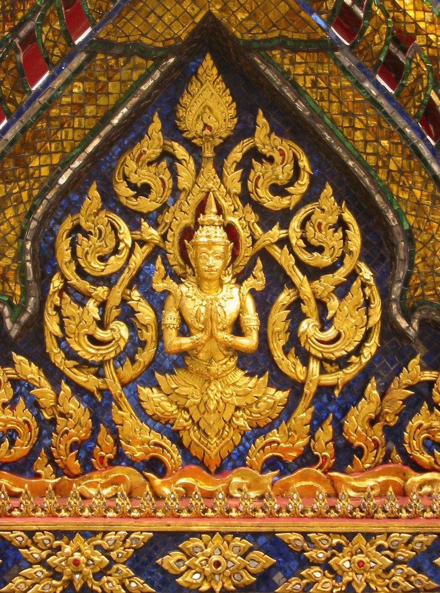 a golden buddha statue on display in a building