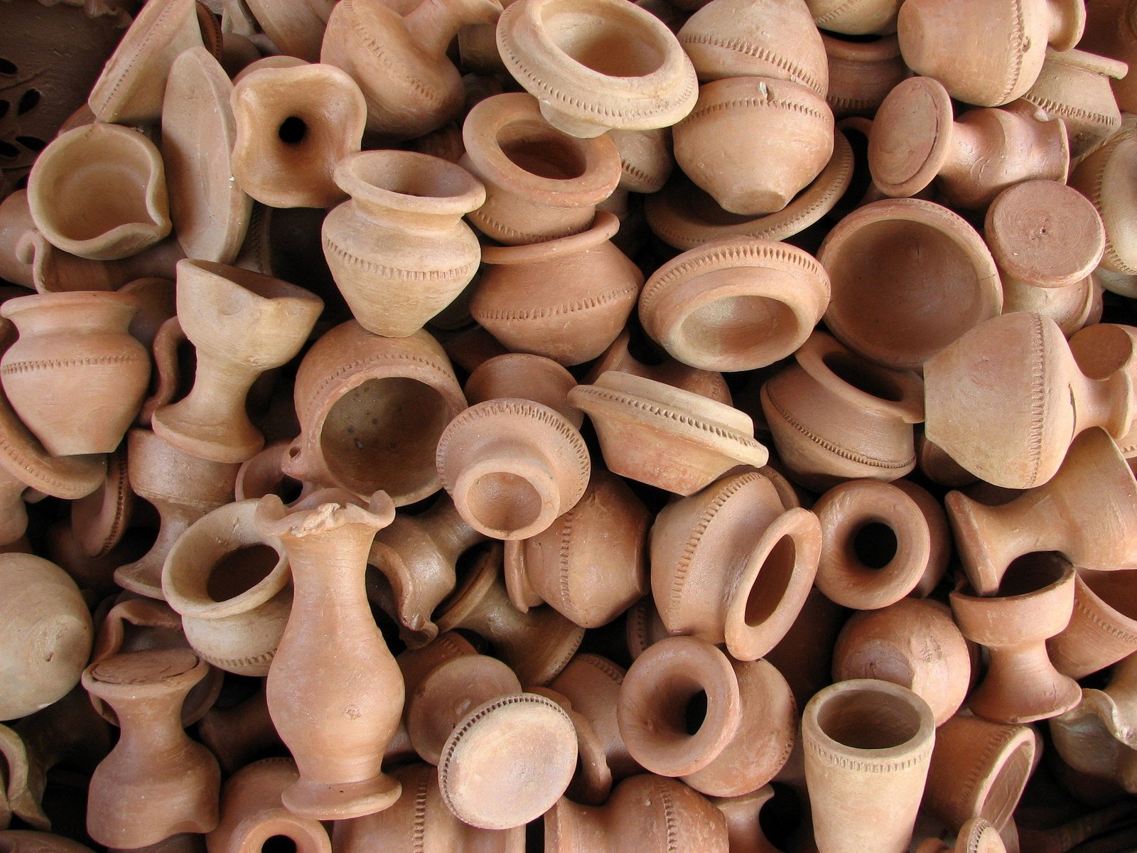 a pile of clay pots with no tops